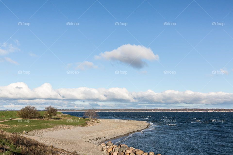 Clouds above the ocean and the beach 