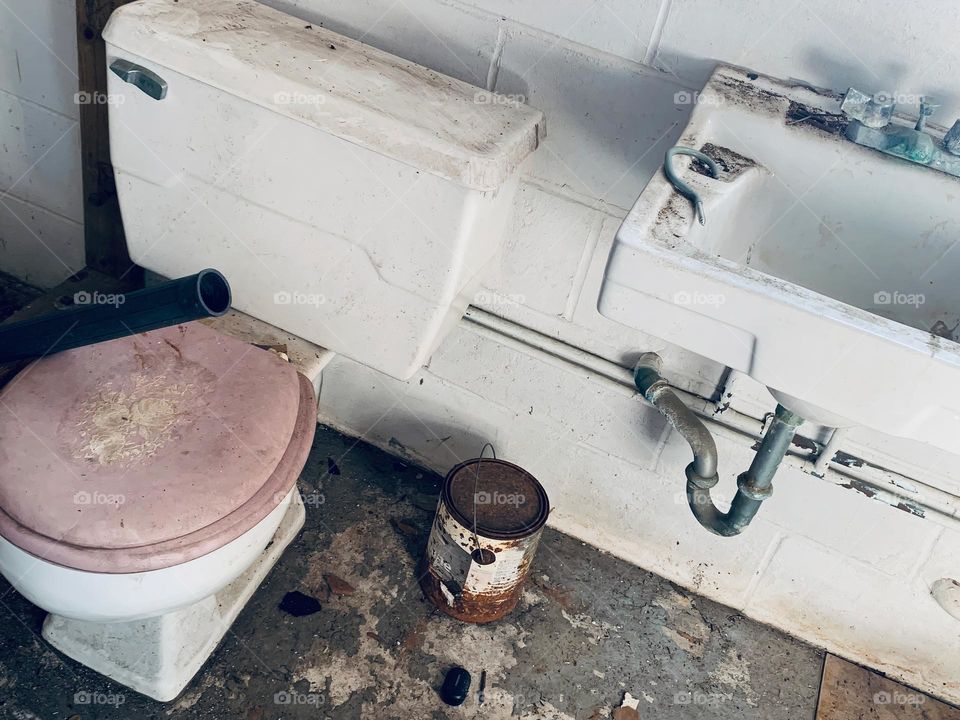 Abandoned And Needing To Be Restored Bathroom With Rusted And Destroyed Elements. 