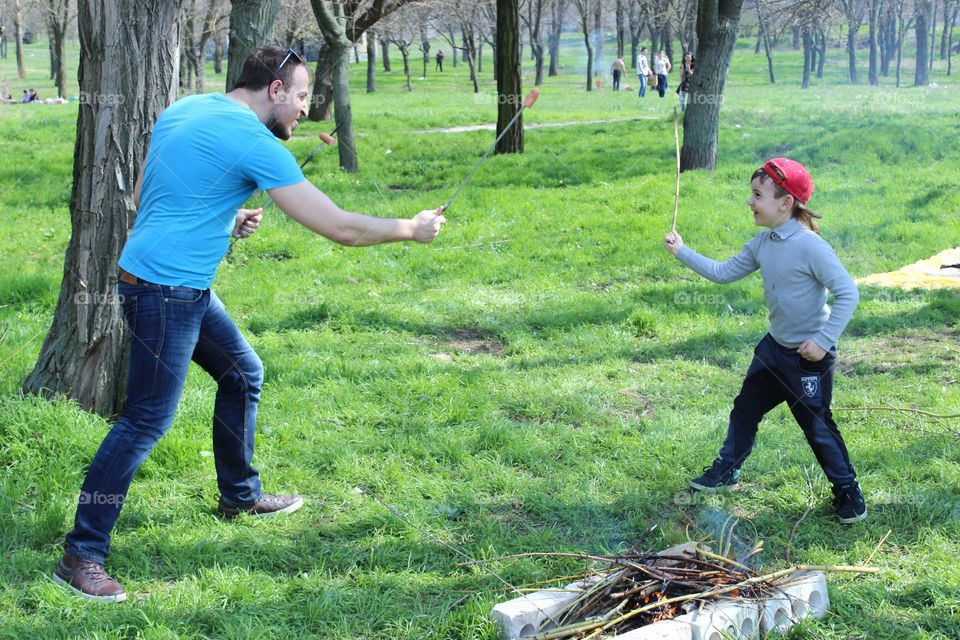 dad playing with son in the park
