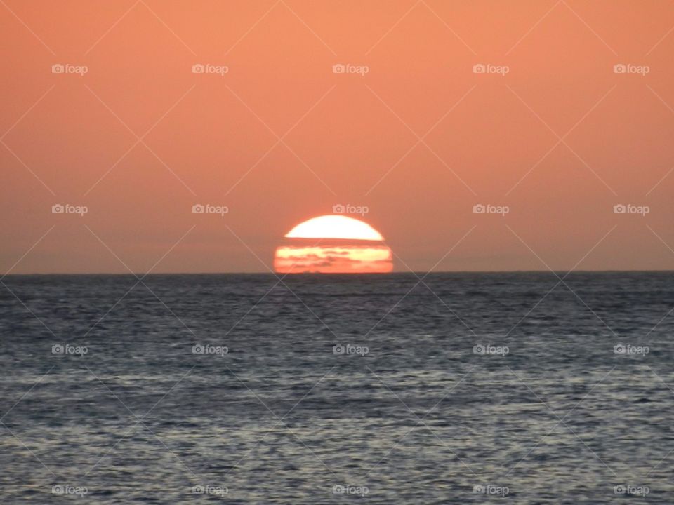 View of sun setting at the horizon