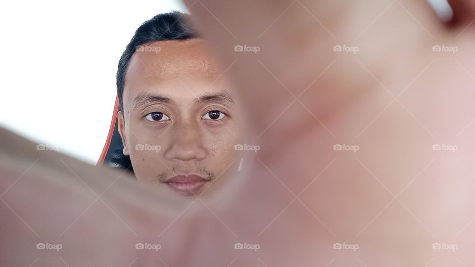 Asian male face taking selfie