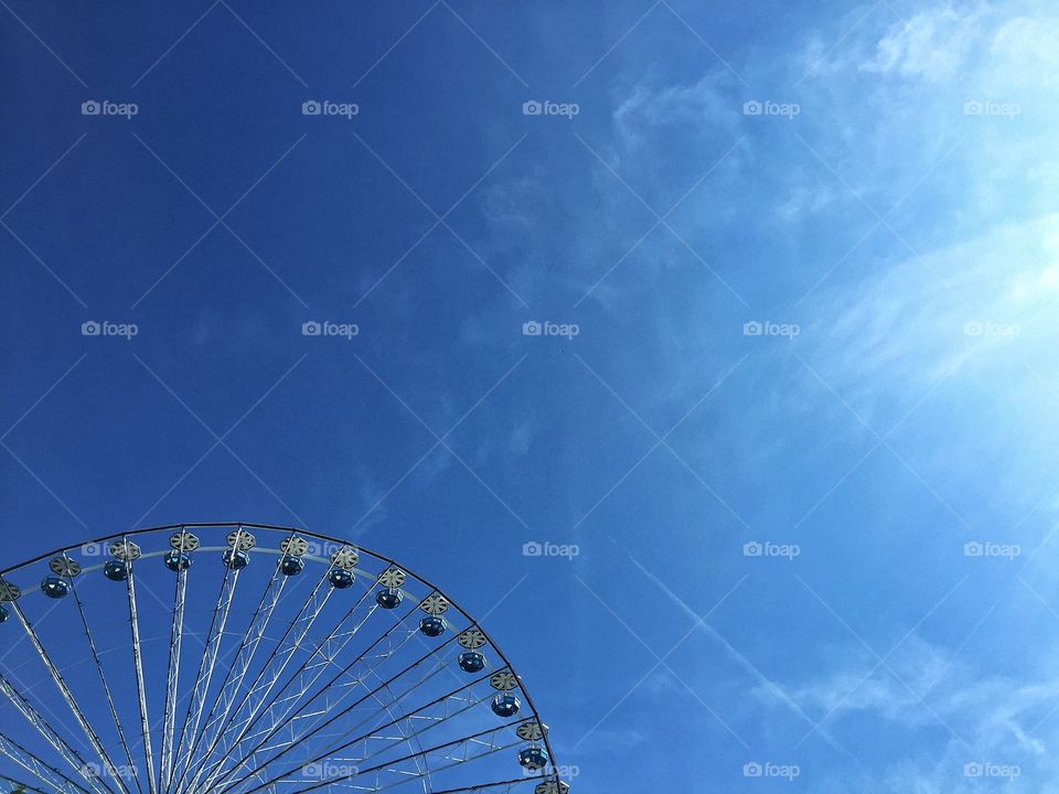 Ferris wheel in a blue sky