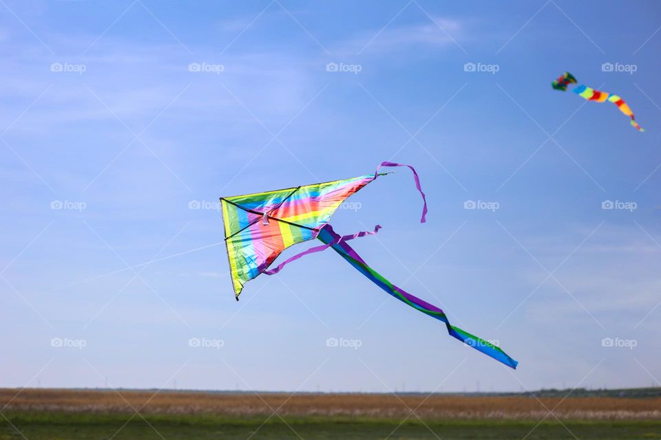 Kite in pride colors flying in the sky 