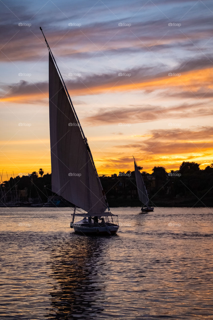 Sailing to see sunset over Nile river in Aswan , Egypt 