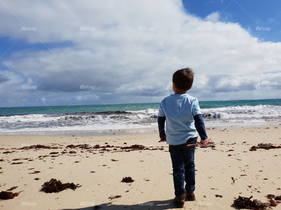boy at a beach near Perth, Australia, looking towards the sea