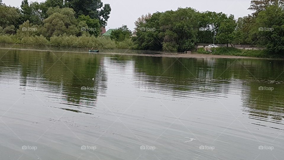 lake in spring with fisherman