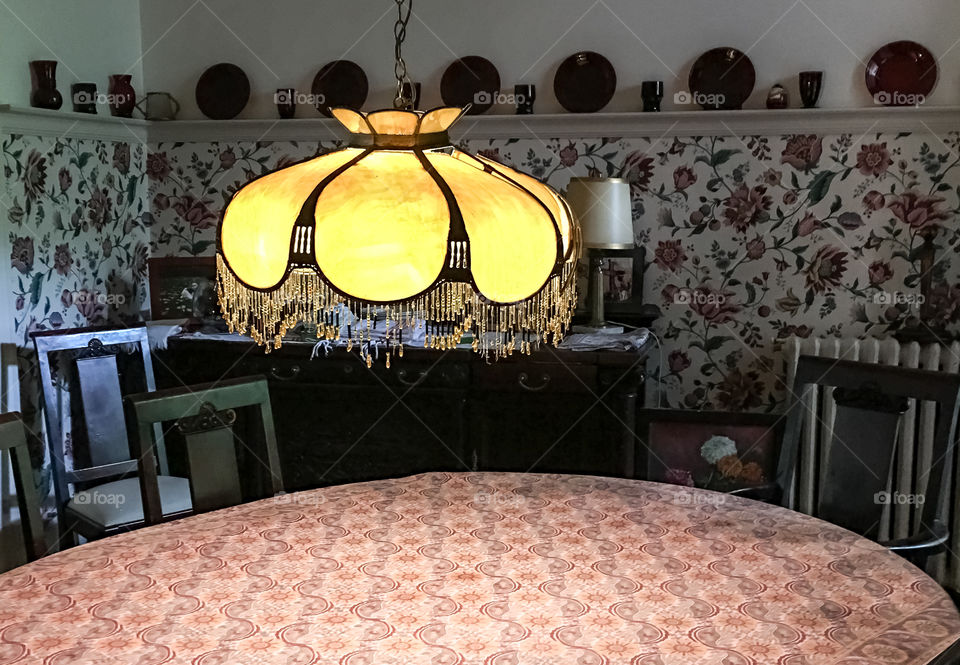 Antique Victorian Tiffany hanging lamp in Victorian dining room illuminated