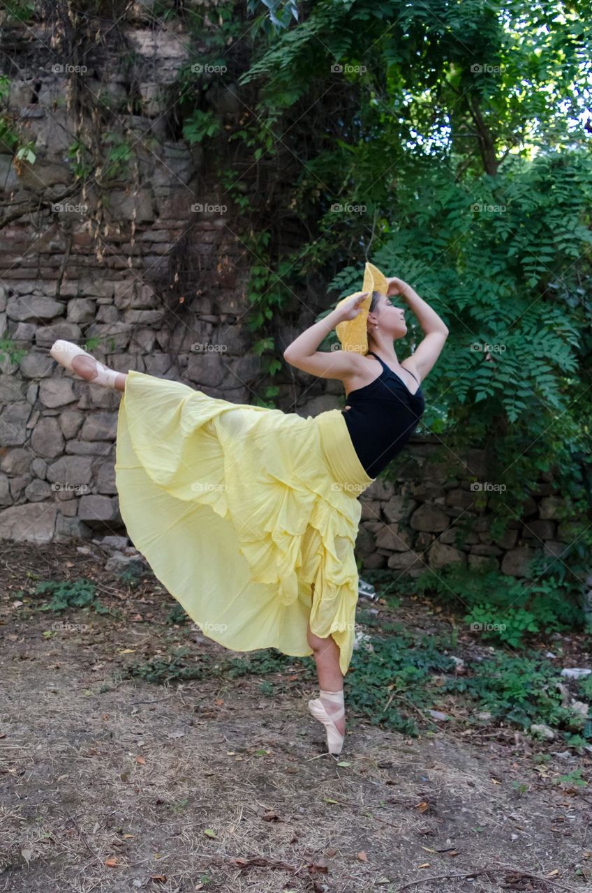 Young Female Ballerina Dancing Outside in Nature