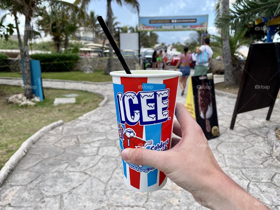 Male hand holding cup with Icee slushed ice at Isla Mujeres, Mexico. The Icee Company is an American beverage company.