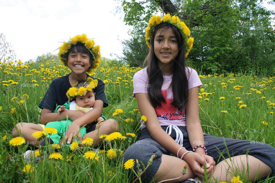 Sibling sitting on flower field