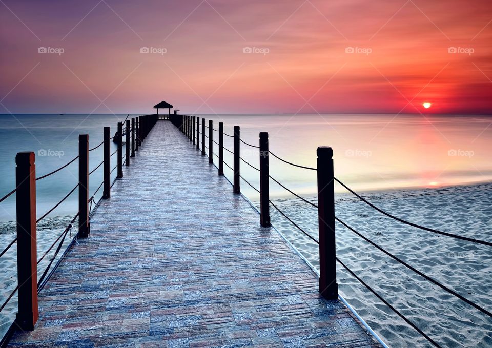 Jetty on the sunset background