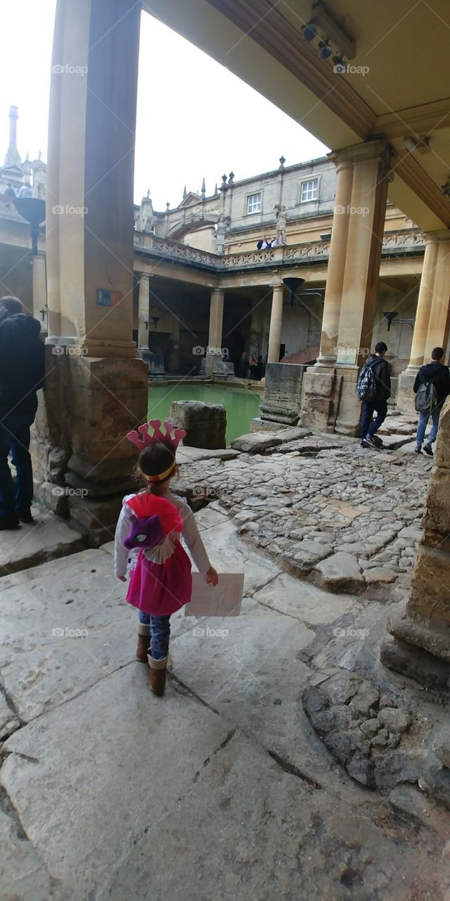 girl standing looking in wonder at ancient building