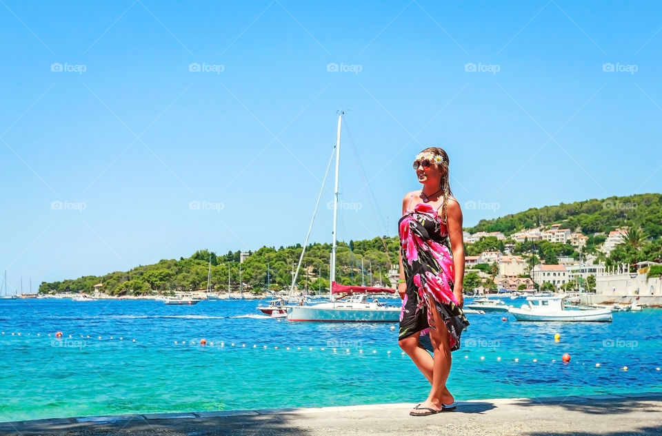 Beautiful woman standing near the sea