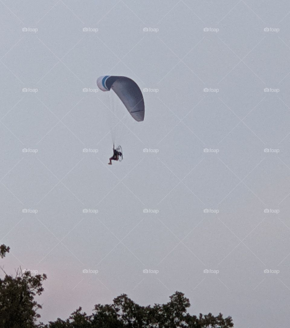 Paraplane flying on a summer evening