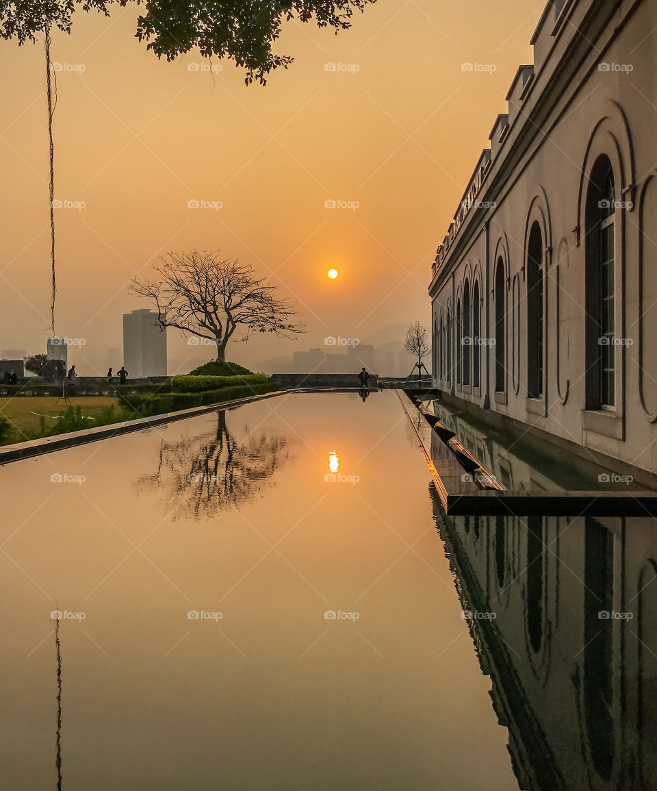 Reflection of Sunset in a century old museum’s pool park.