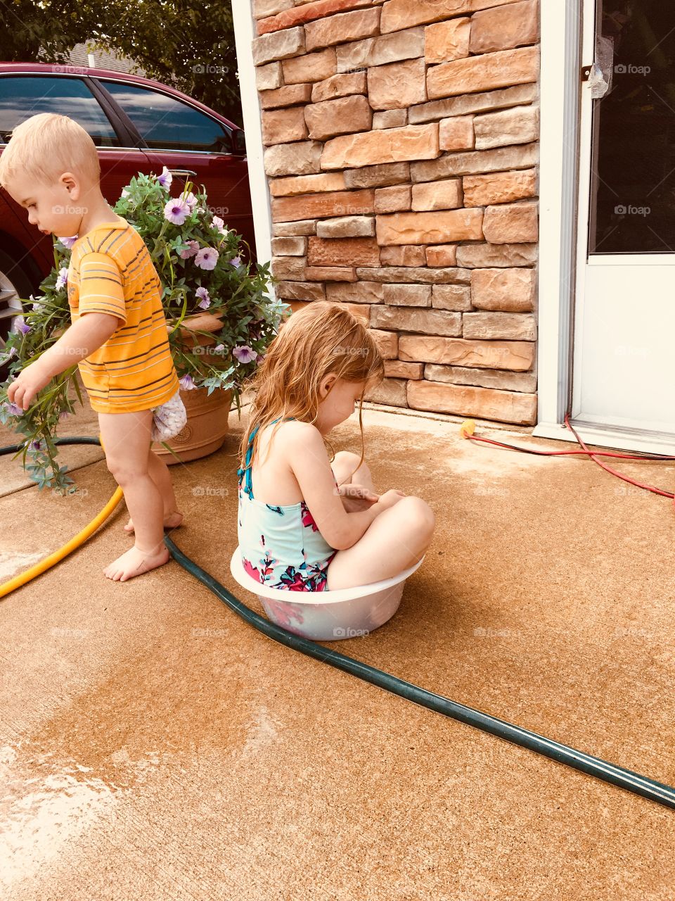 Children playing in the garden hose