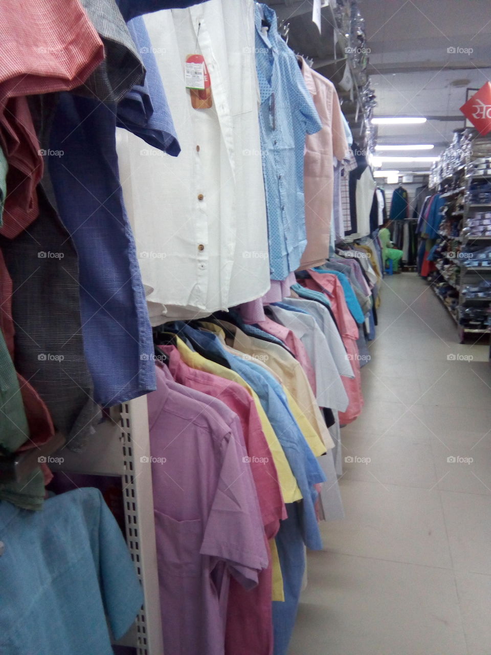 different kinds of shirts hanging in a mall in India