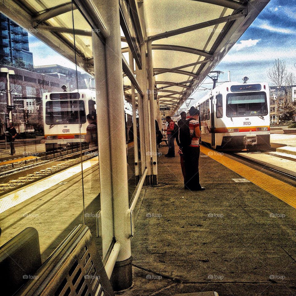 Reflection of Transport commute. The Denver transit system reflecting off the glass at Union Station.  Denver, Co