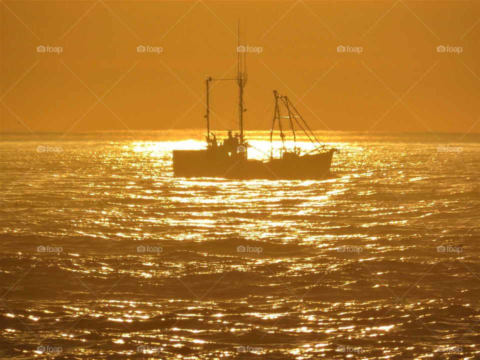 Silhouette of boat during sunset