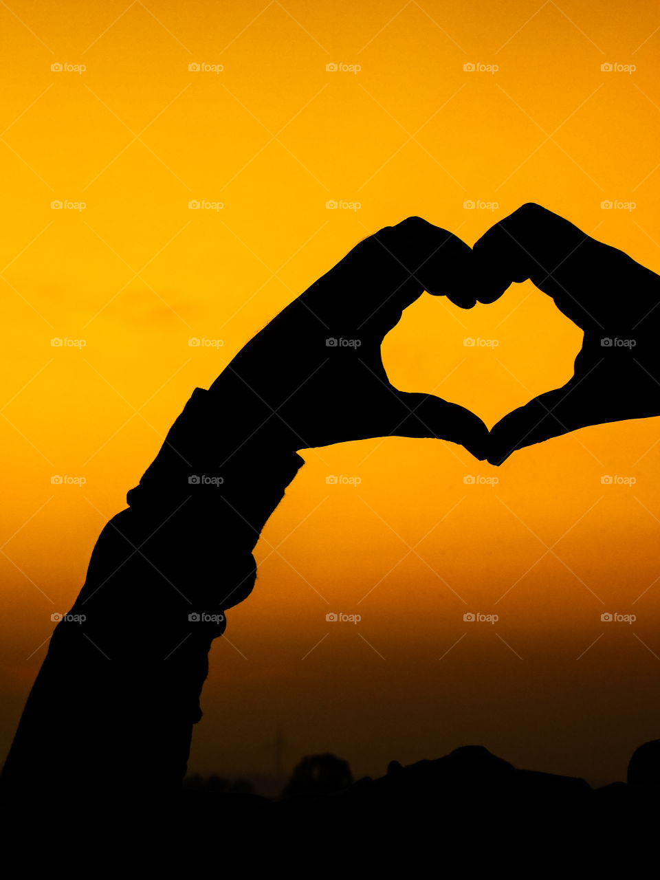Silhouette image or wallpaper - Love wallpaper or heart shaped hand posture with beautiful after sunset golden light background.I love 2019 very much.
