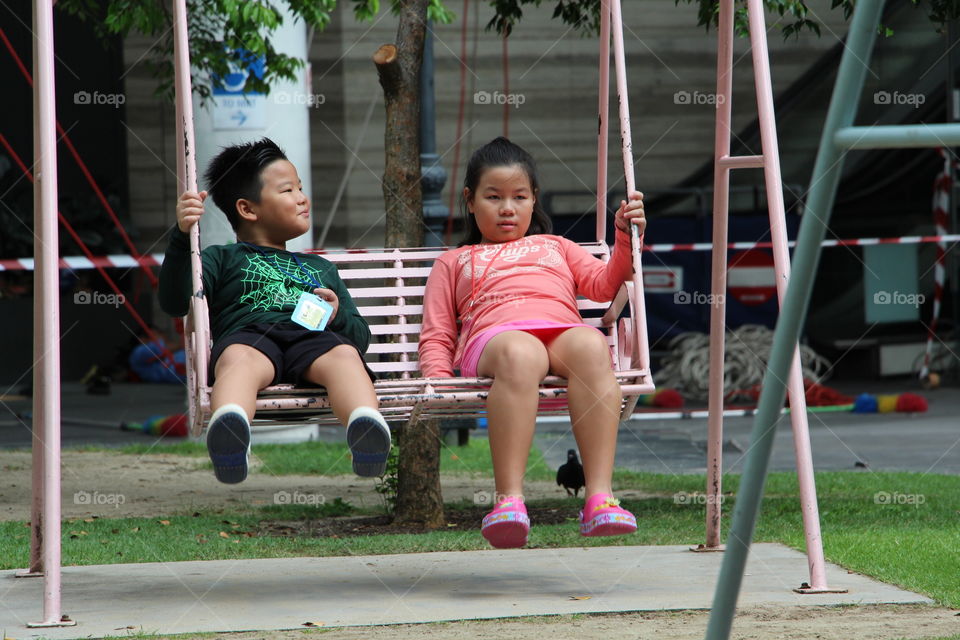 Siblings on a Swing