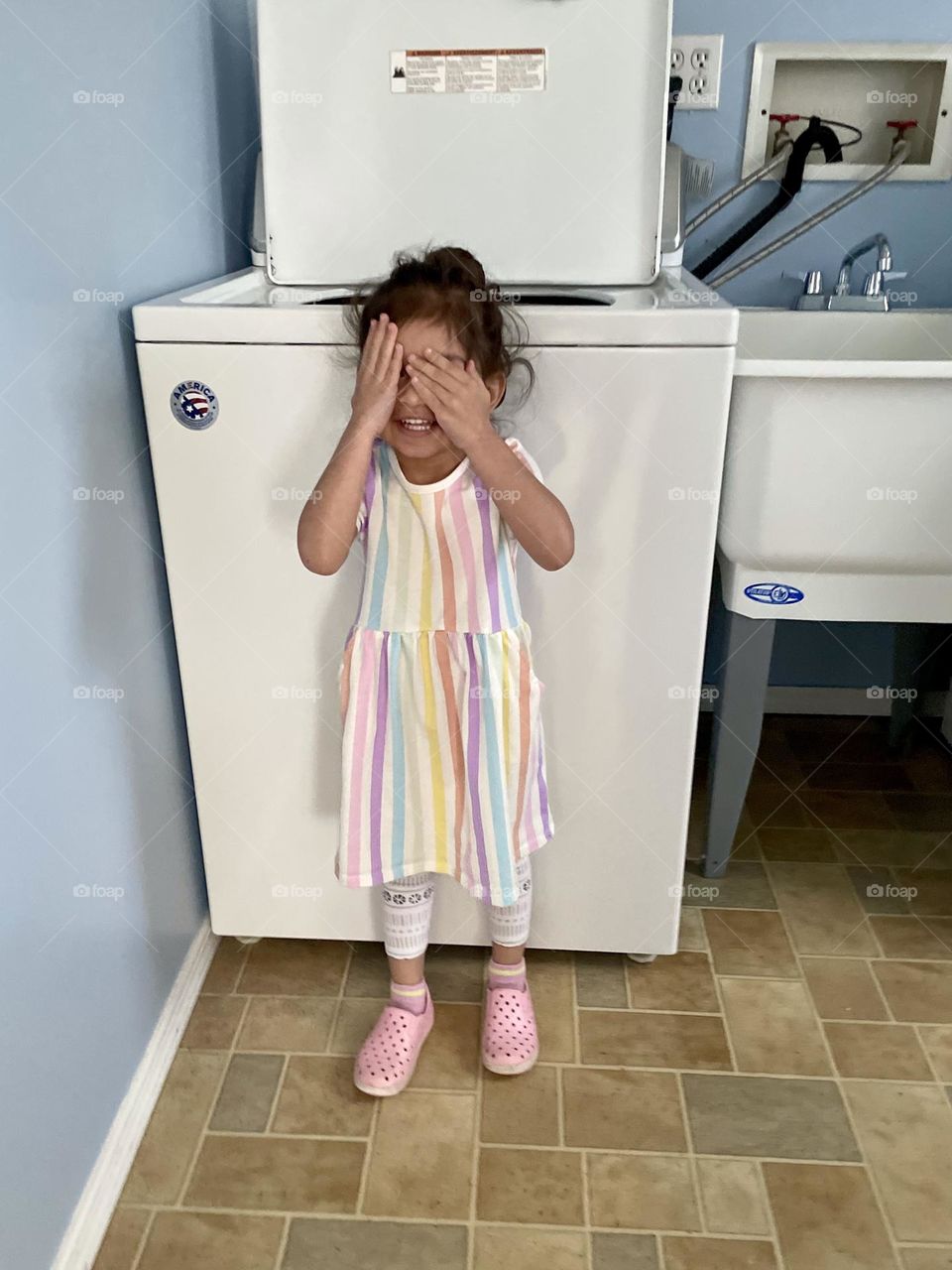 Little girl plays hide and seek, ready or not here I come, counting for hide and seek, playing peekaboo, toddlers and hide and seek, playing games indoors