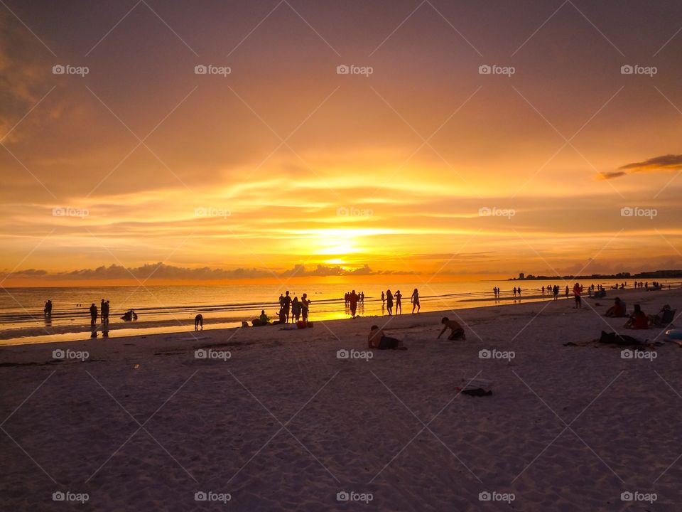 Siesta Key beach goers at sunset. Siesta Key beach at sunset