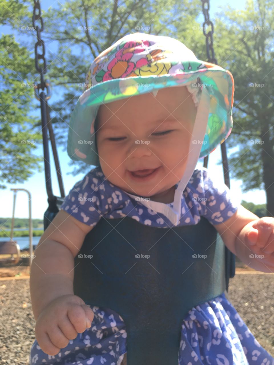 Cute girl enjoying on swing in park