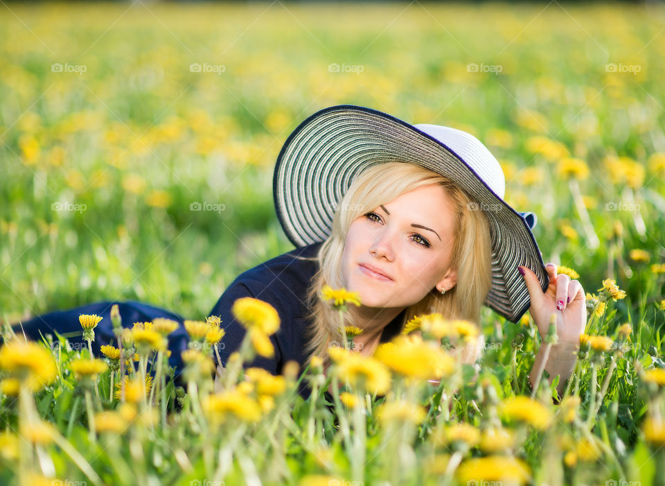 Beautifu woman in a dandelion meadow