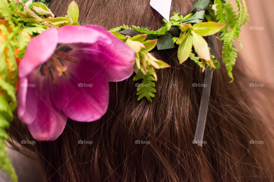 Closeup of woman wearing flower crown tulip garland on hair 