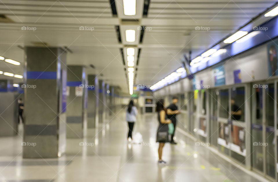 Blurry image of a passenger stand waiting for the subway