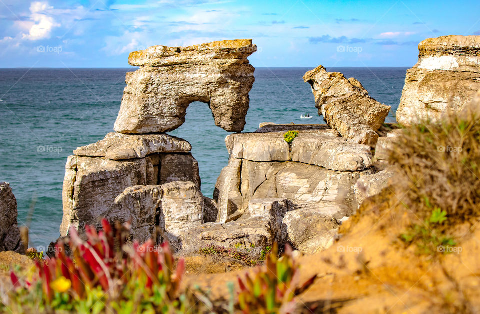 Unusual rock formations create a window out on to the Atlantic Ocean on the coast at Peniche, Portugal 