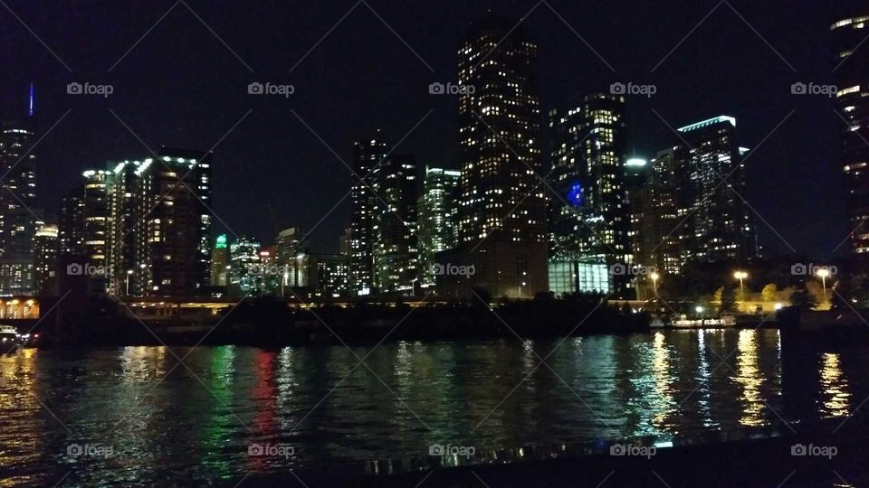 Chicago skyline at night with river reflection