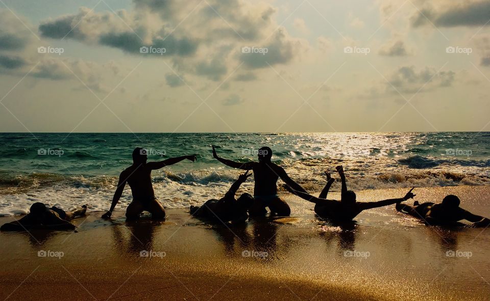 Group of male friends having fun at beach