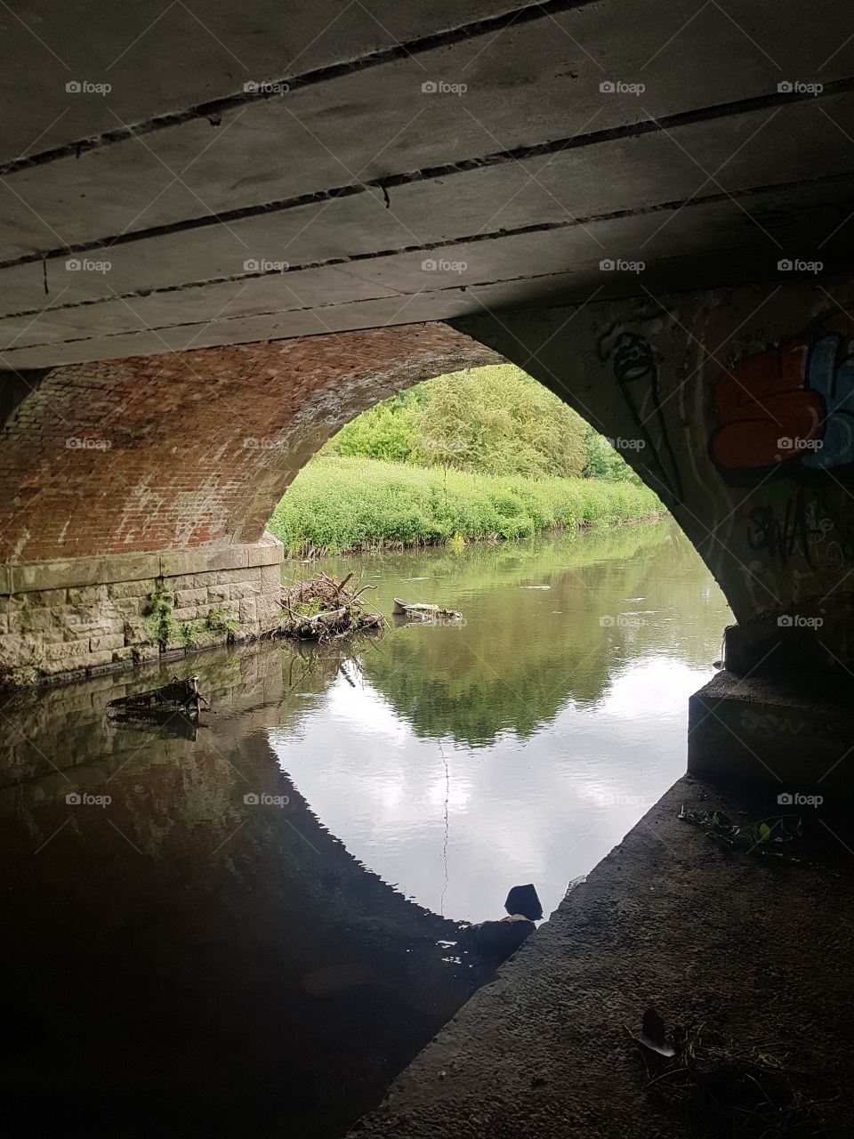 reflections on clear Crystal waters under a railway bridge