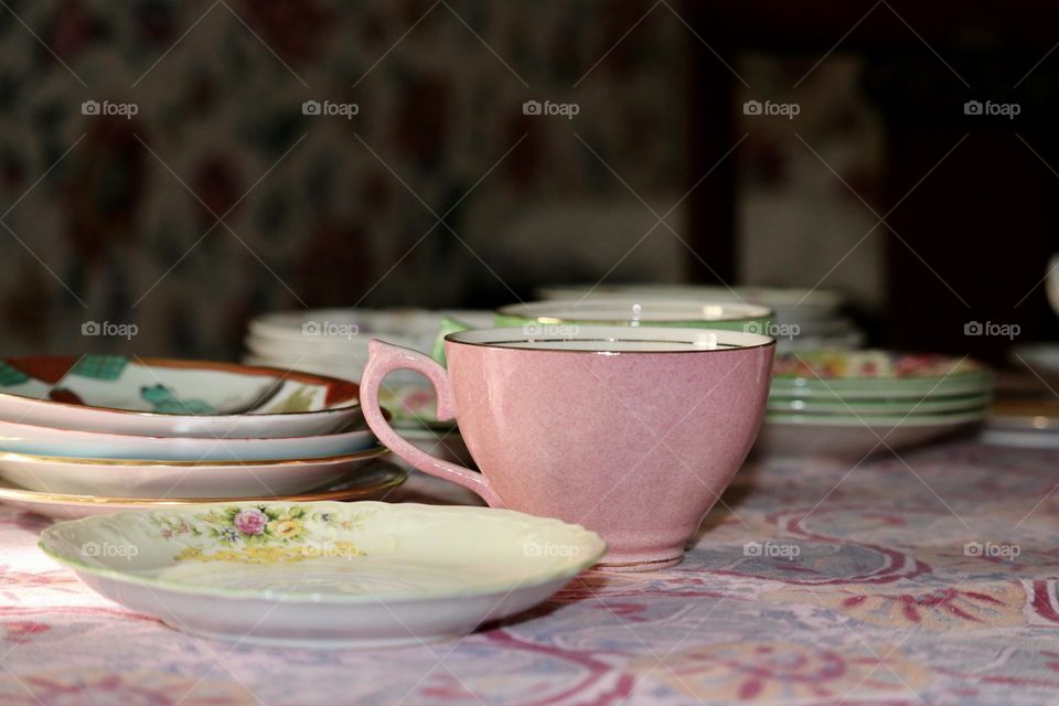 Baby pink vintage porcelain teacup on table, with assorted porcelain china collection 