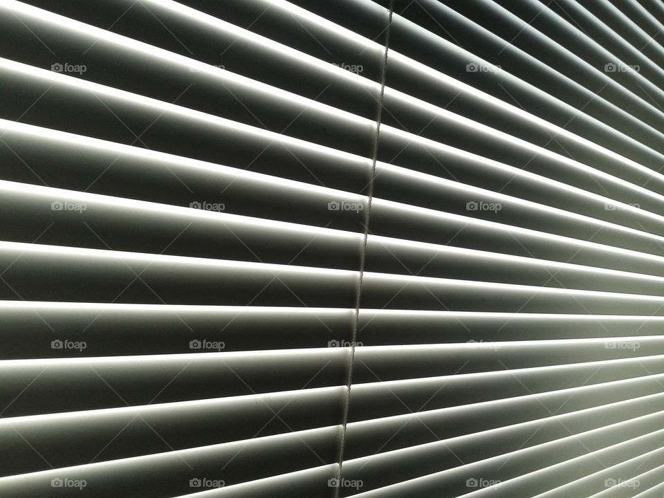 Blind. Venetian blind closed in the mid afternoon