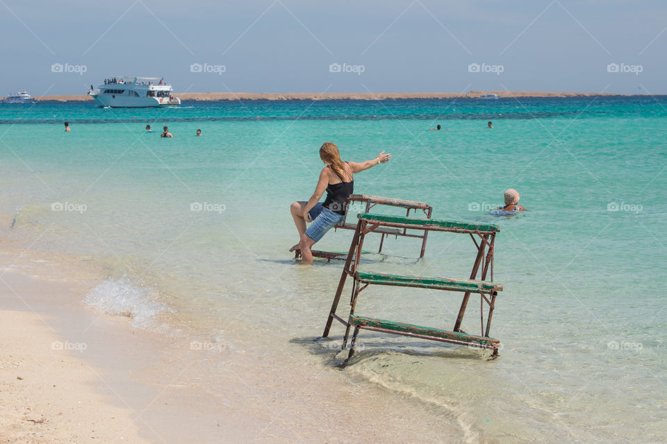 Woman staying by the beach watching and playing with the beautiful air. 
Giftun Island, Hurghada