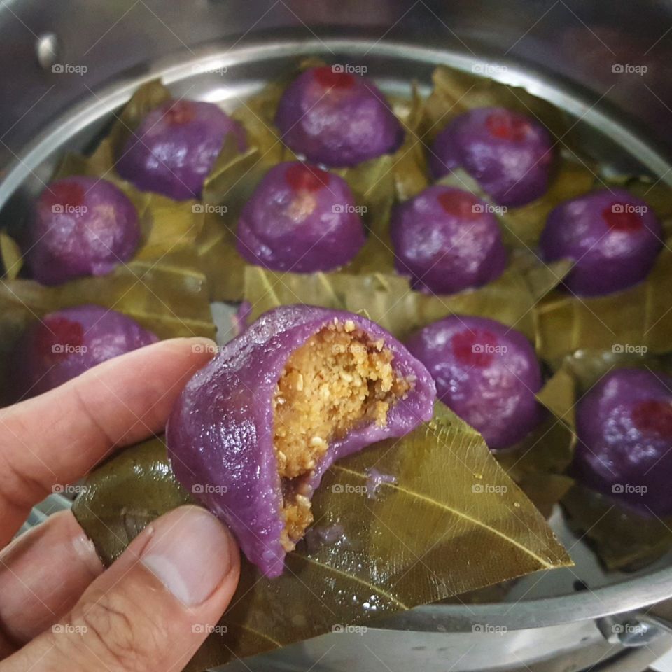 Homemade Nyonya kueh using purple sweet potato for the colouring of the glutinous rice skin. The filling is toasted peanut sesame seed and sugar.