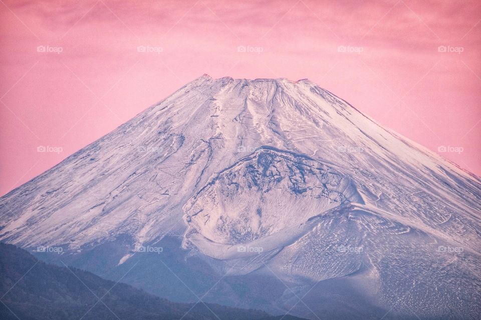 Strange view of Fuji mountain on pink sky background in twilight moment at Kawaguchiko lake , Japan