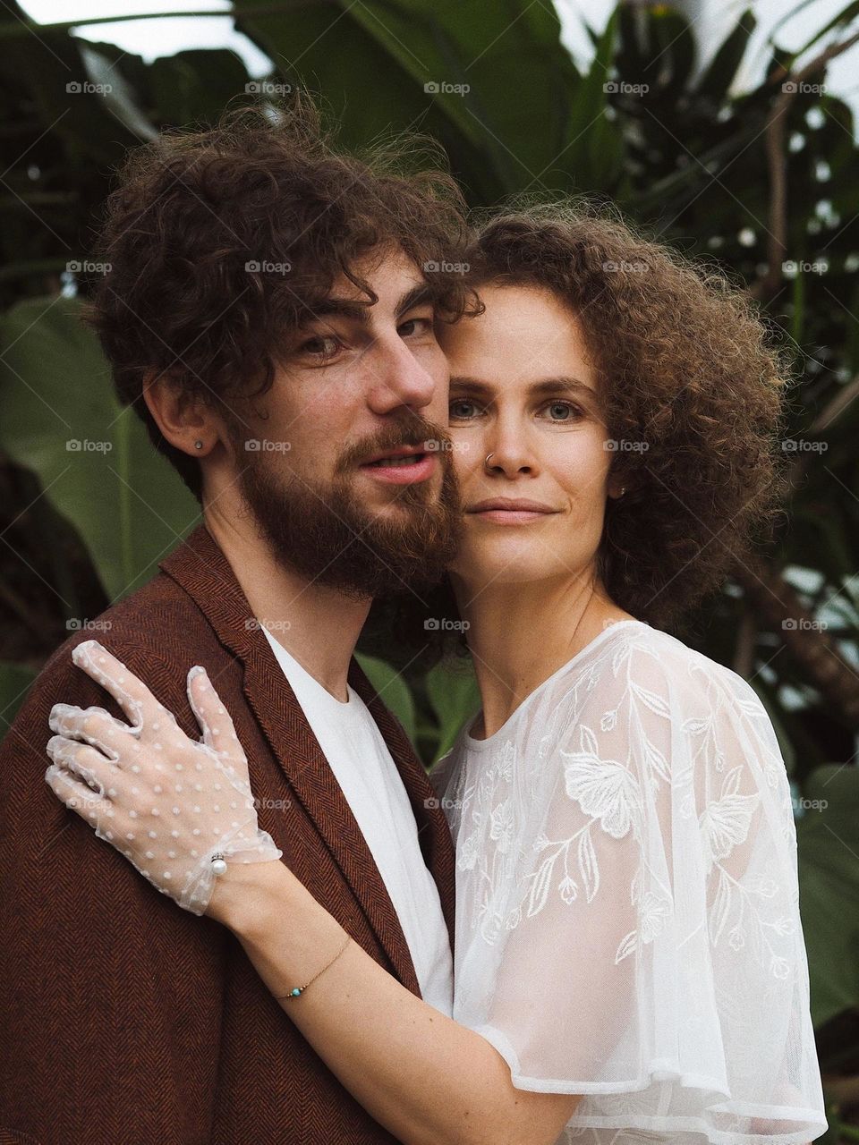 Beautiful young lovers in botanical garden 