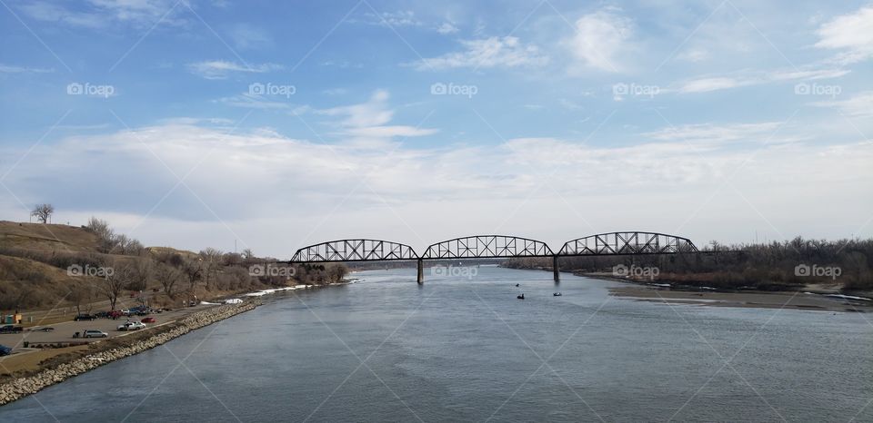 Distant bridge over a cold spring river. 