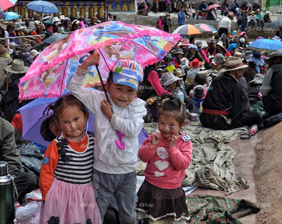 cute girls on the monastery yard in shigatse during buddha festival celebration in tibet