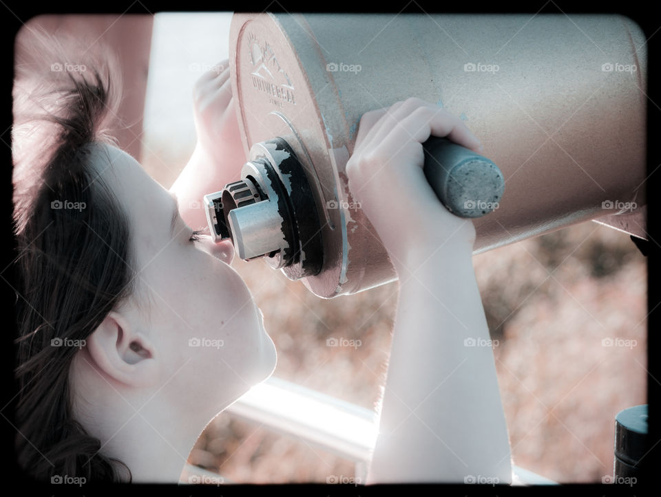 A girl looking through the telescope