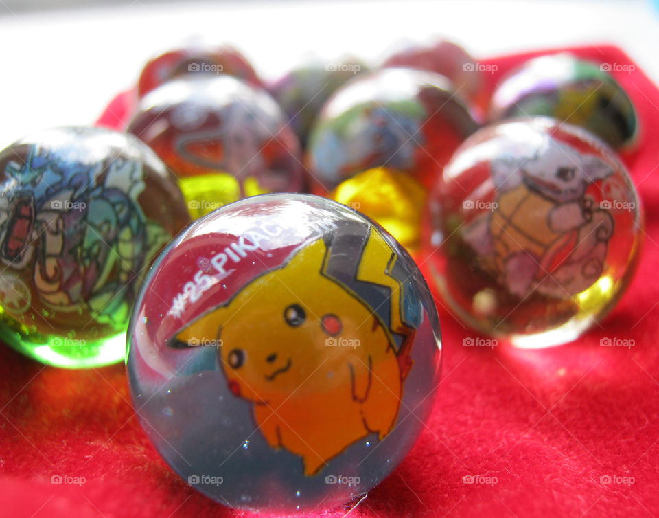 Pokémon glass marbles with natural lighting.