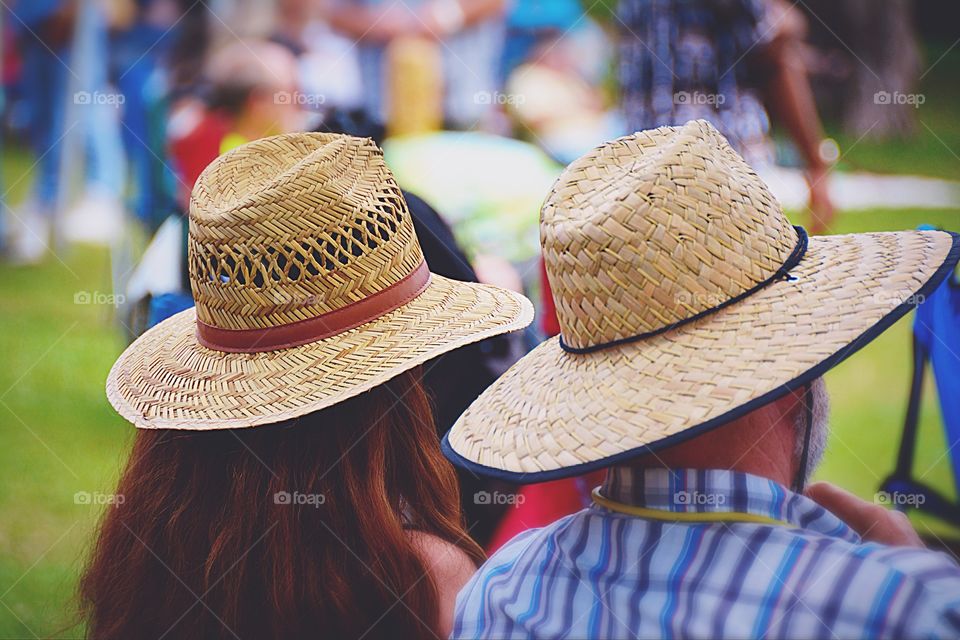 Rear view of man and woman with hats