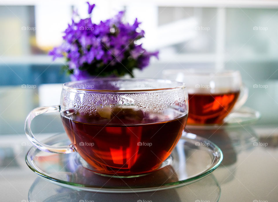 Hot cup of tea on table