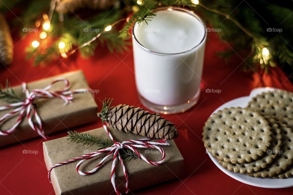 Christmas treat homemade cookies and milk on a red background. Craft gifts and cones