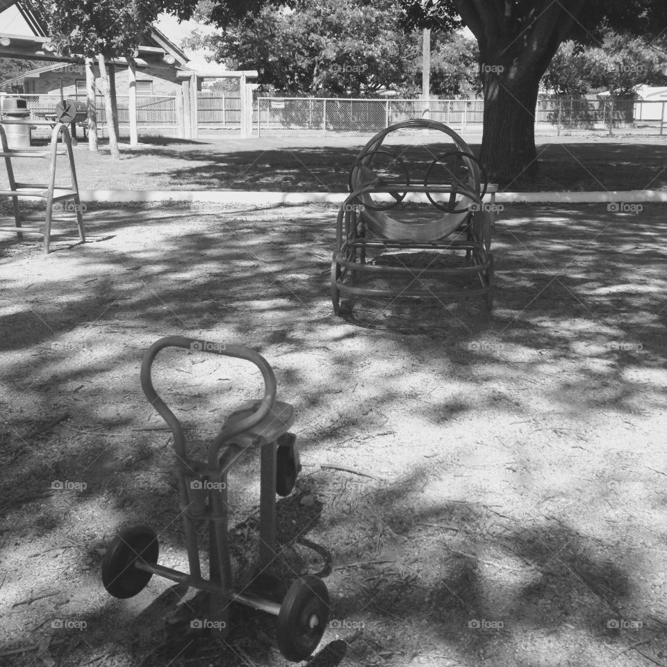 Black and white photo of vintage toys at a park.