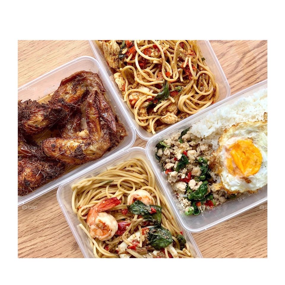 Spicy Thai western fusion meal with noodles , rice and chicken wings 